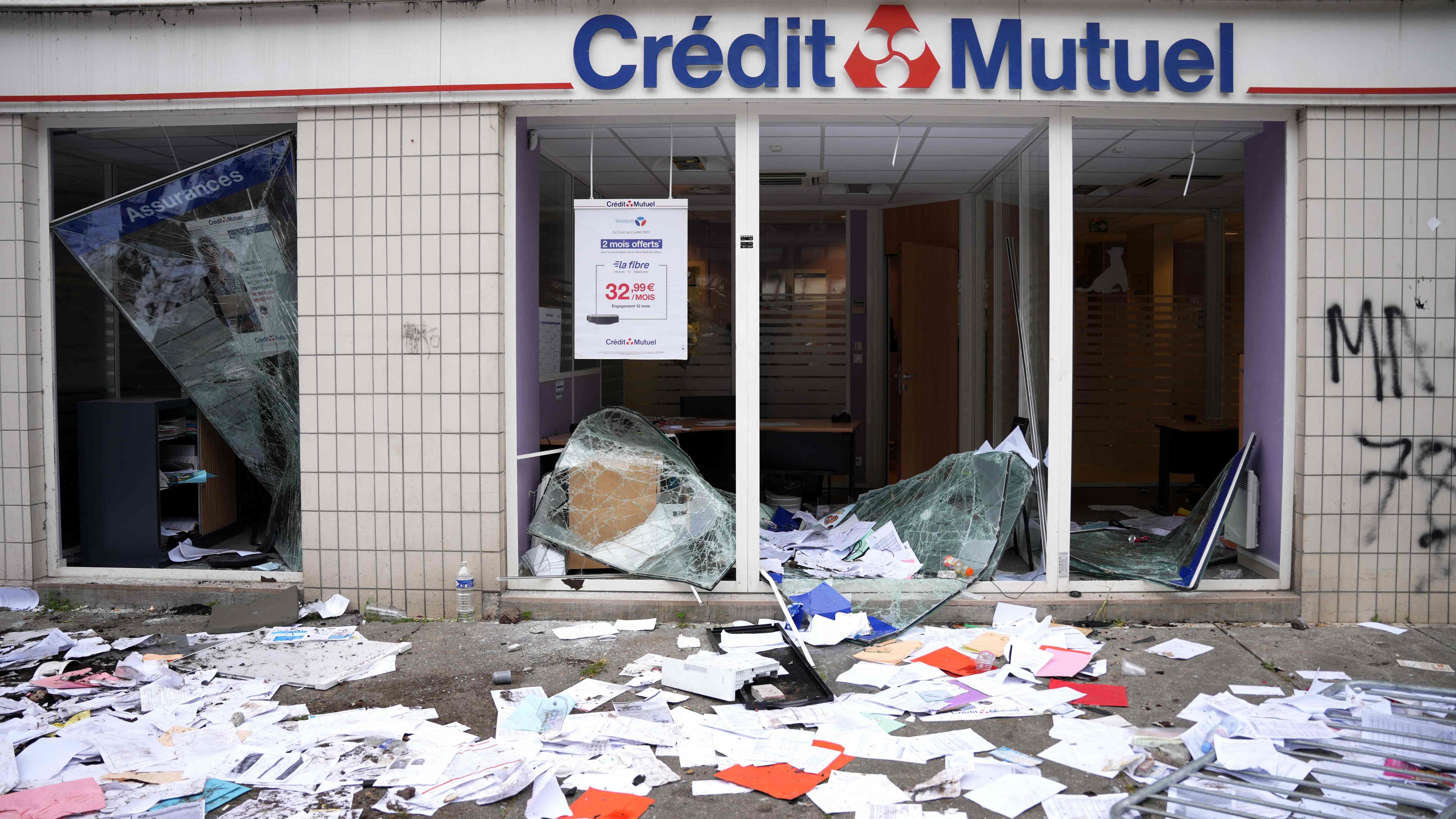 office of French bank Credit Mutuel damaged following riots that broke out after a commemoration march for a teenage driver shot dead by a policeman