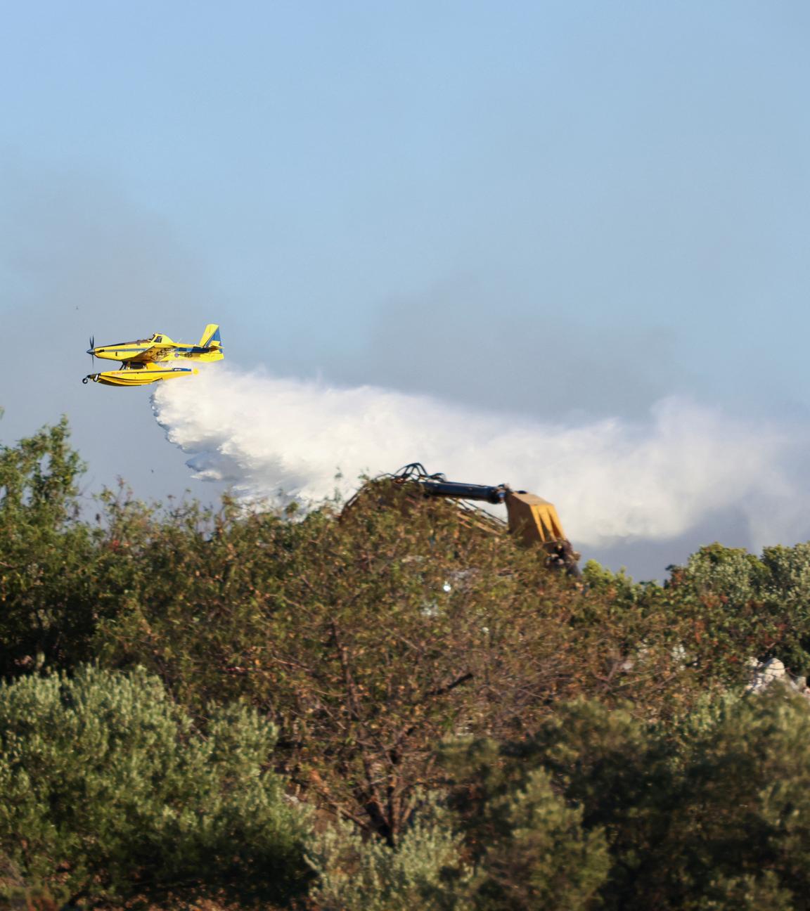 Ein Löschflugzeug wirft Wasser auf ein Feuer auf der Insel Ciovo, Kroatien, 27. Juli 2023.