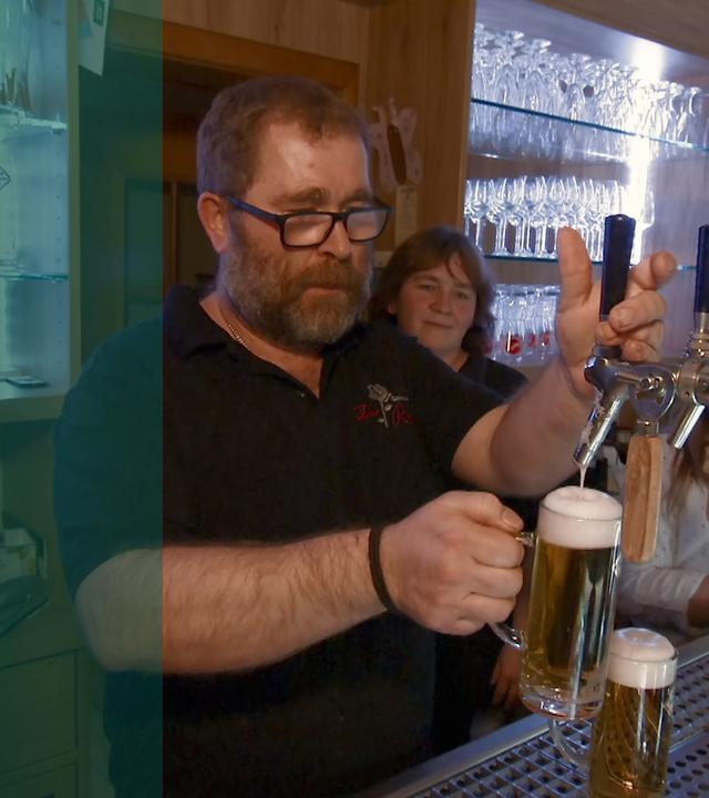 Mann am Tresen einer Dorfkneipe