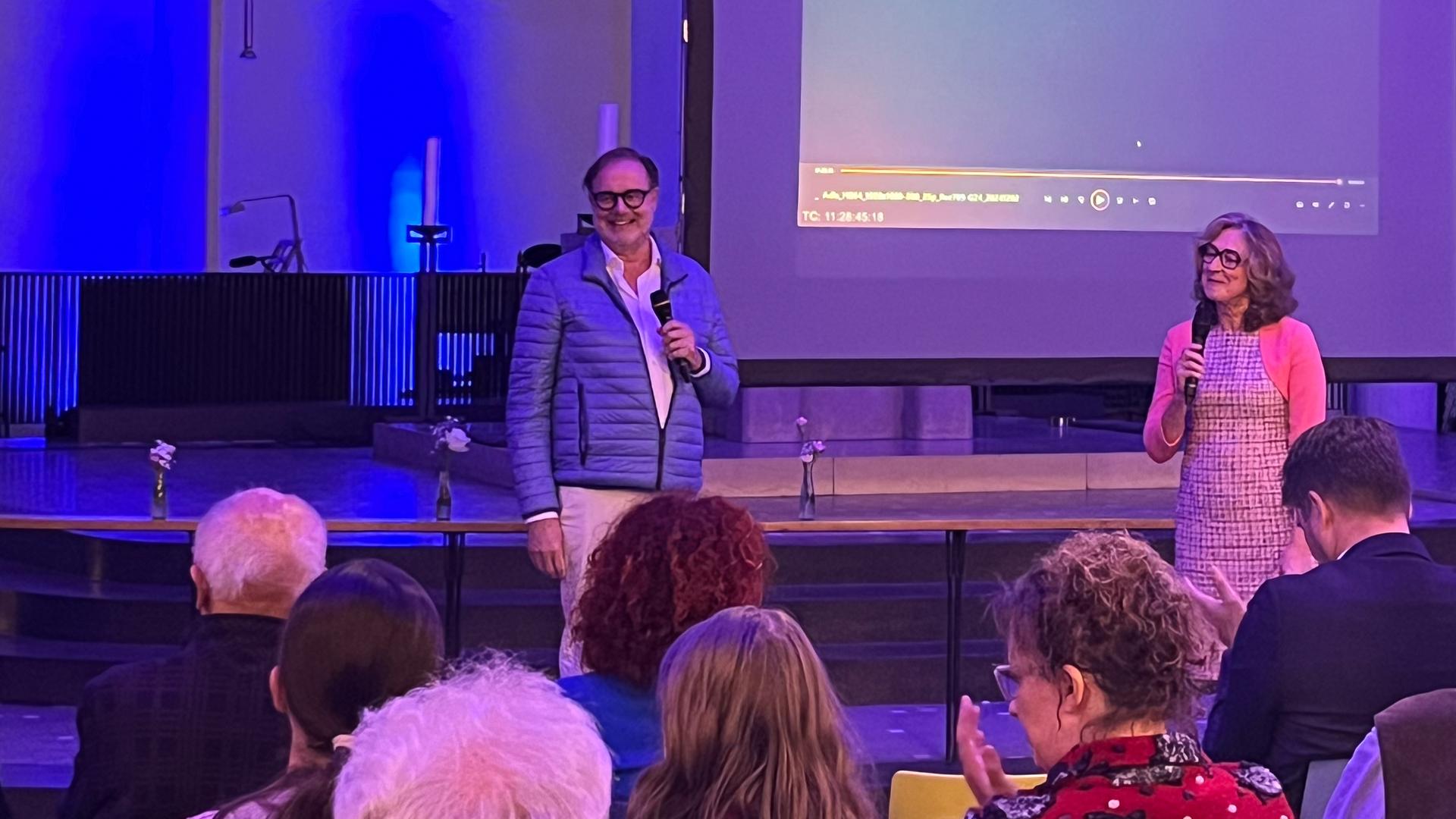 Filmproduzent Mark von Seydlitz und ZDF-Landesstudioleiterin Susanne Freitag-Carteron stehend vor einer Zuschauergruppe bei der Filmbesprechung "Ein Tag im September"