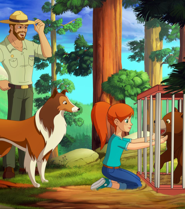 Zoé kniet vor dem Käfig, in welchem sich der Bär befindet. Lassie steht hinter ihr.