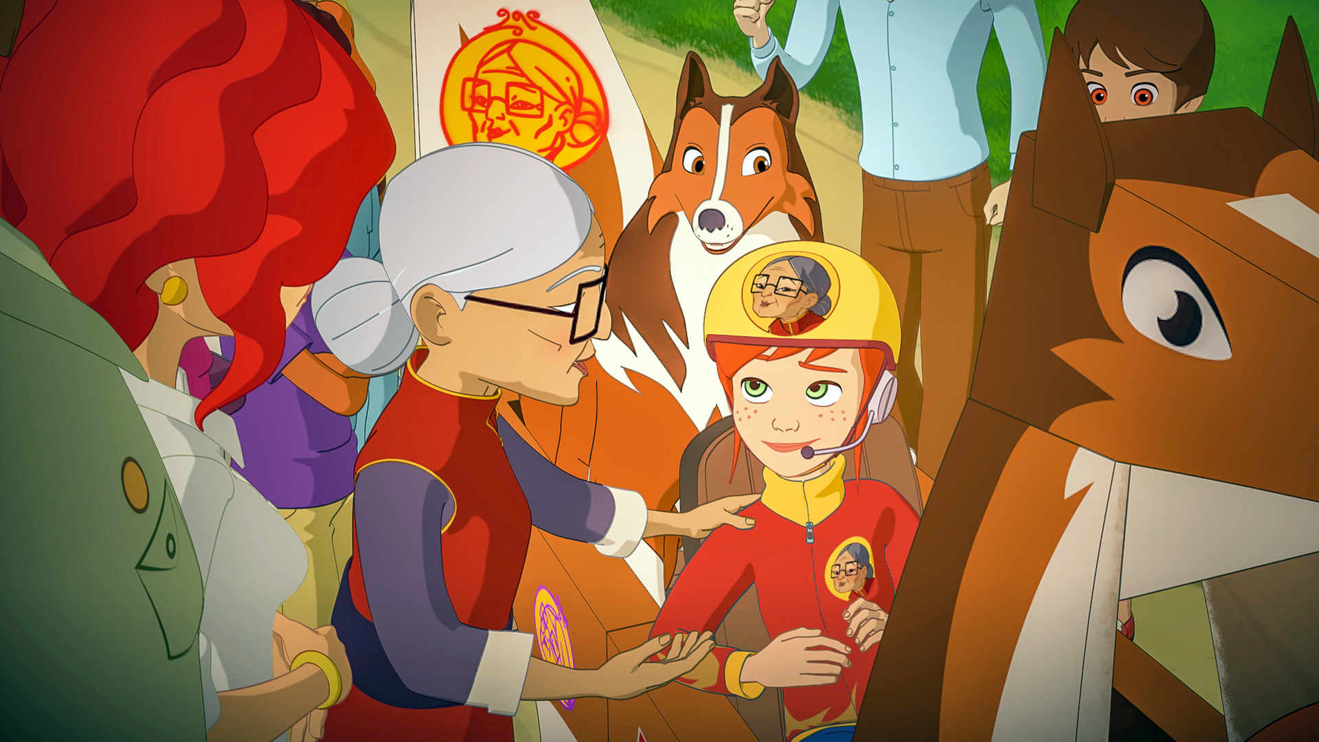 Hinter der Zieleinfahrt sitzen Zoé und Lassie in ihrer Seifenkiste. Mrs. Lee steht neben Zoé und fasst sie an der Schulter an. Die beiden sind von weiteren Menschen umringt.