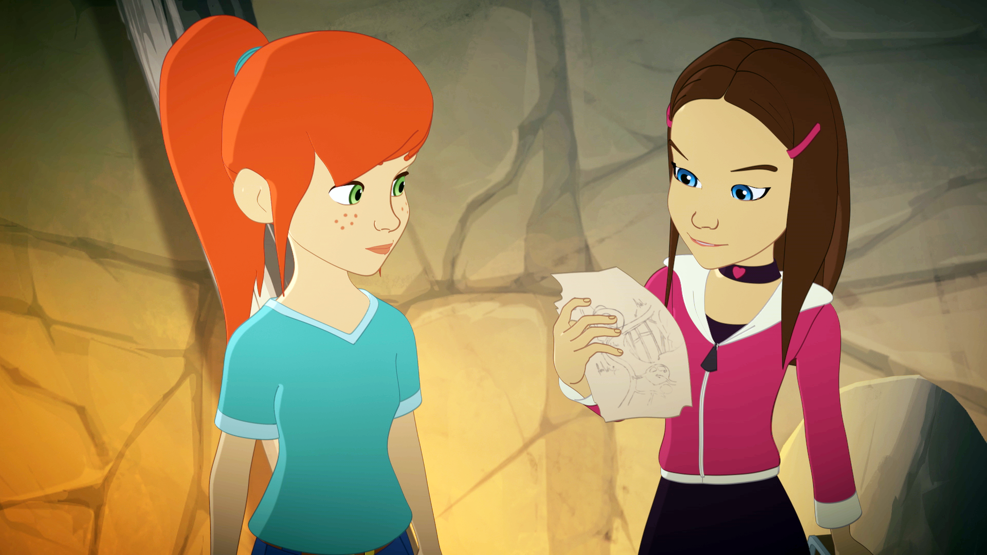 In einem Bergwerksstollen steht Zoé neben Samantha, die ein Blatt mit einer Zeichnung darauf in der Hand hält. 