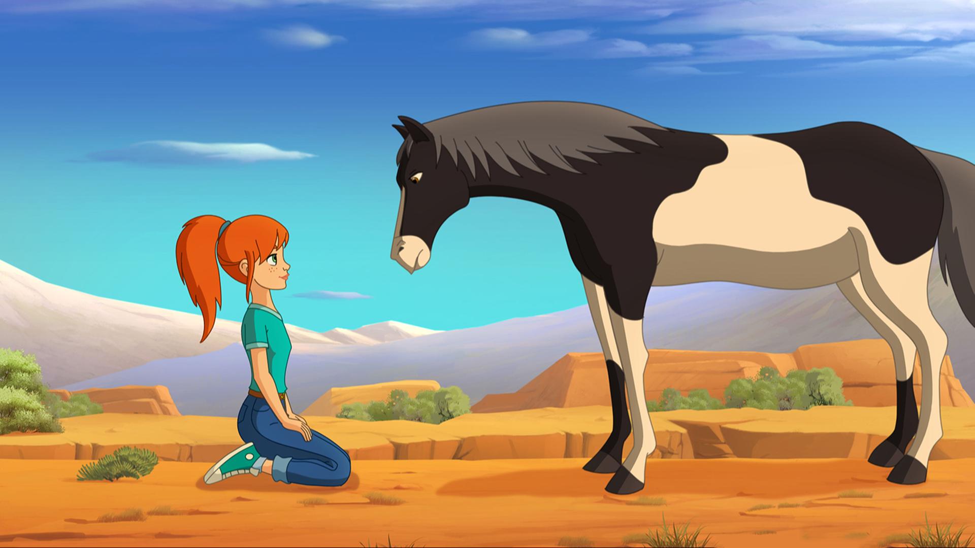Zoé kniet vor einem Wildpferd nieder, welches ihr gegenübersteht und sie kritisch beäugt.