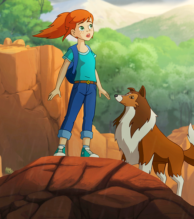 Lassie und Zoé stehen auf einem Felsvorsprung und halten Ausschau.