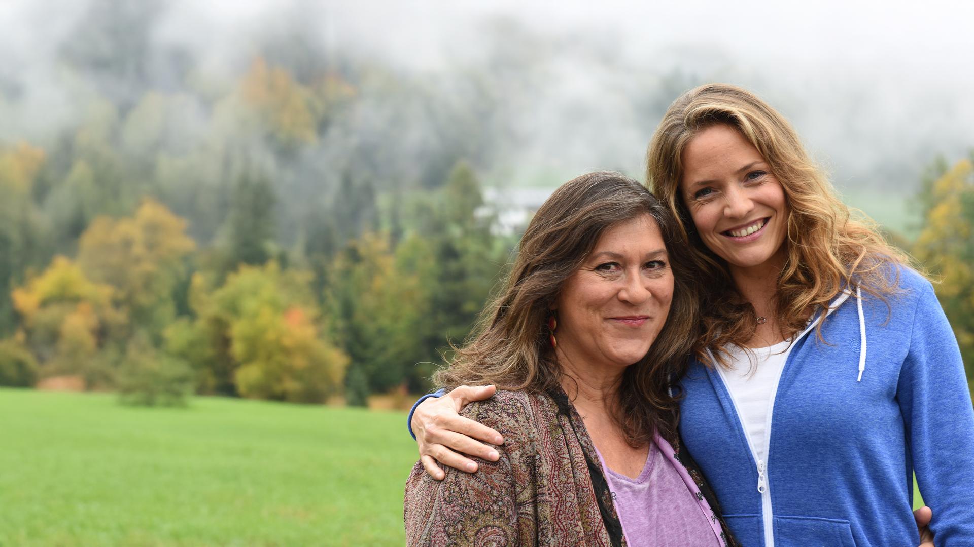 "Lena Lorenz - Entscheidung fürs Leben": Lena Lorenz (Patricia Aulitzky) und ihre Mutter Eva (Eva Mattes) stehen Arm in Arm nebeneinander. Die beiden stehen im Grünen und lachen in die Kamera.