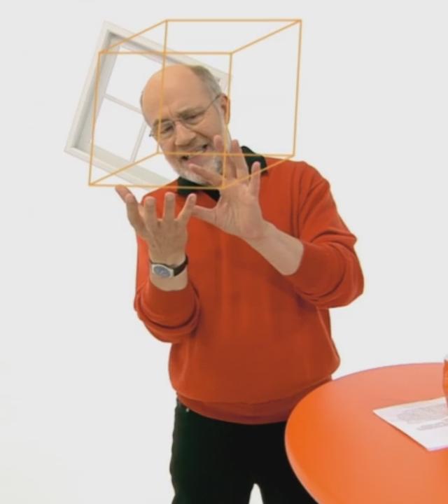 Harald Lesch in seinem Studio mit einem Würfel