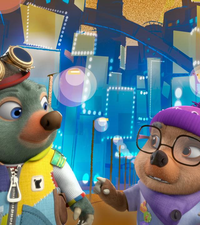 Moley und Dotty stehen gemeinsam mit Lester in einer bunten, virtuellen Zwischenwelt. Diese sieht aus wie eine Theaterbühne.