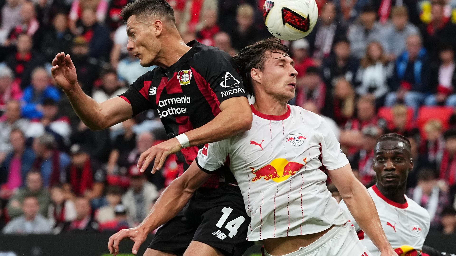 Leverkusens Patrk Schick im Duell mit Leipzigs Willi Orban