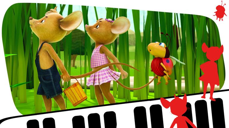 Jo, Naya und Ludwig pusten in Richtung einer Pusteblume, um die Samen zum Fliegen zu bringen.