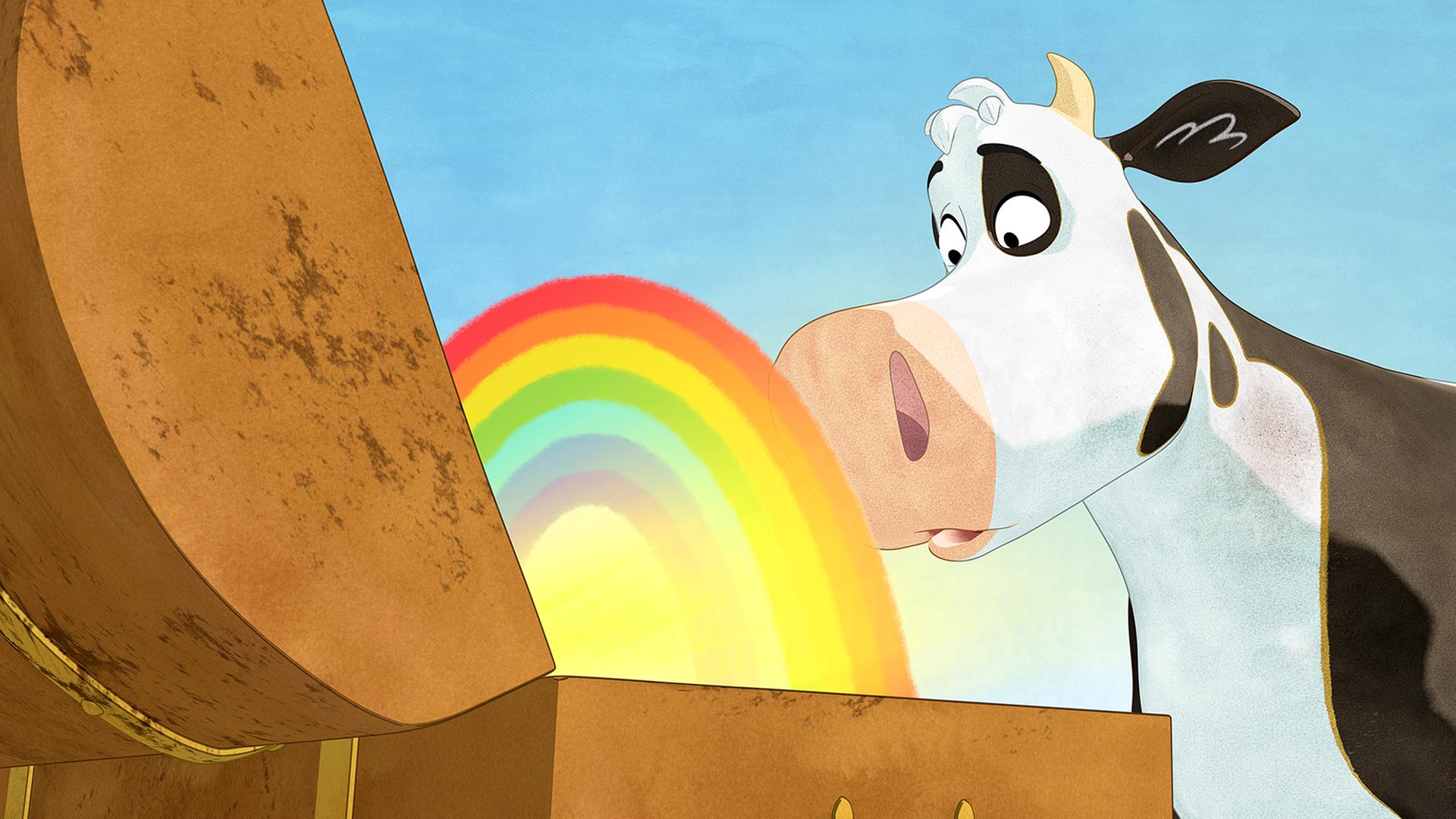 Lieselotte steht staunend vor einer Schatztruhe, aus der ein bunter Regenbogen scheint.