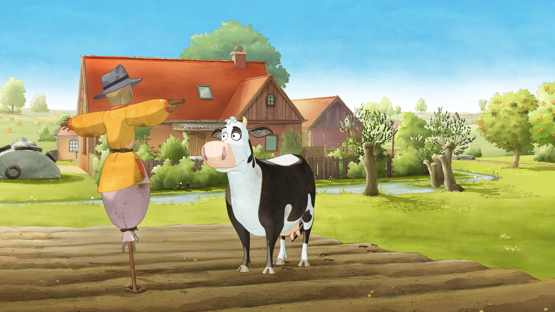 Die Kuh Lieselotte (rechts) steht auf einem Acker vor einer Vogelscheuche.