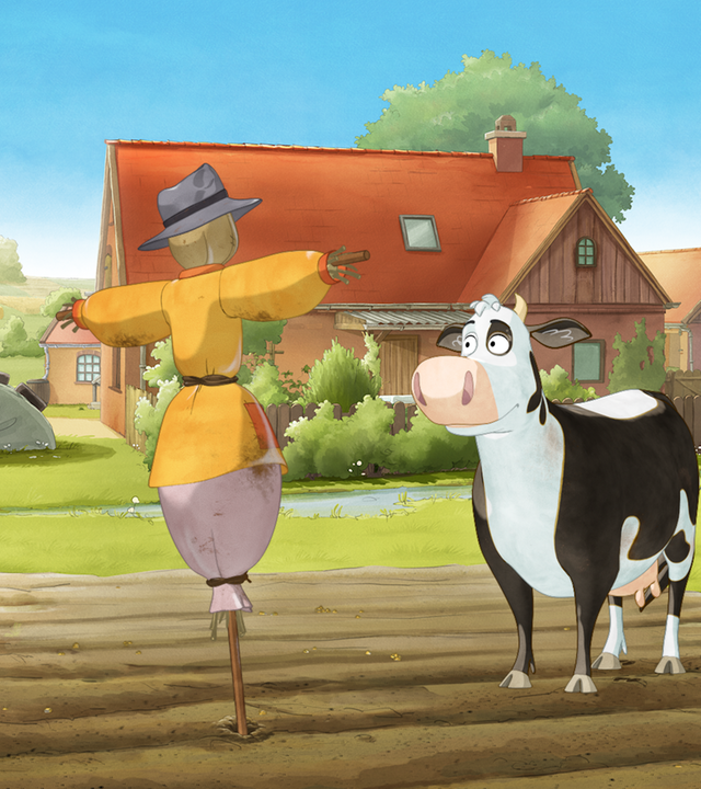 Die Kuh Lieselotte (rechts) steht auf einem Acker vor einer Vogelscheuche.