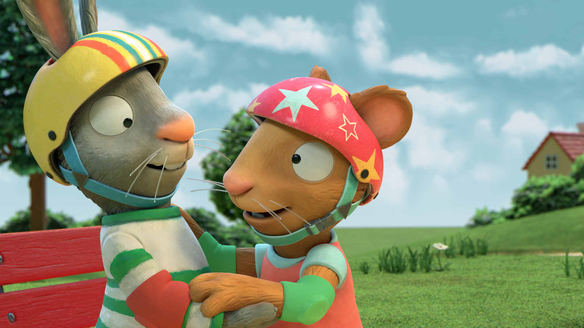 Pip und Posy umarmen sich und haben einen Fahrradhelm auf. Pips Helm ist gelb und ist bunt gestreift, Posys Helm ist rot und hat gelbe und weisse Sterne.