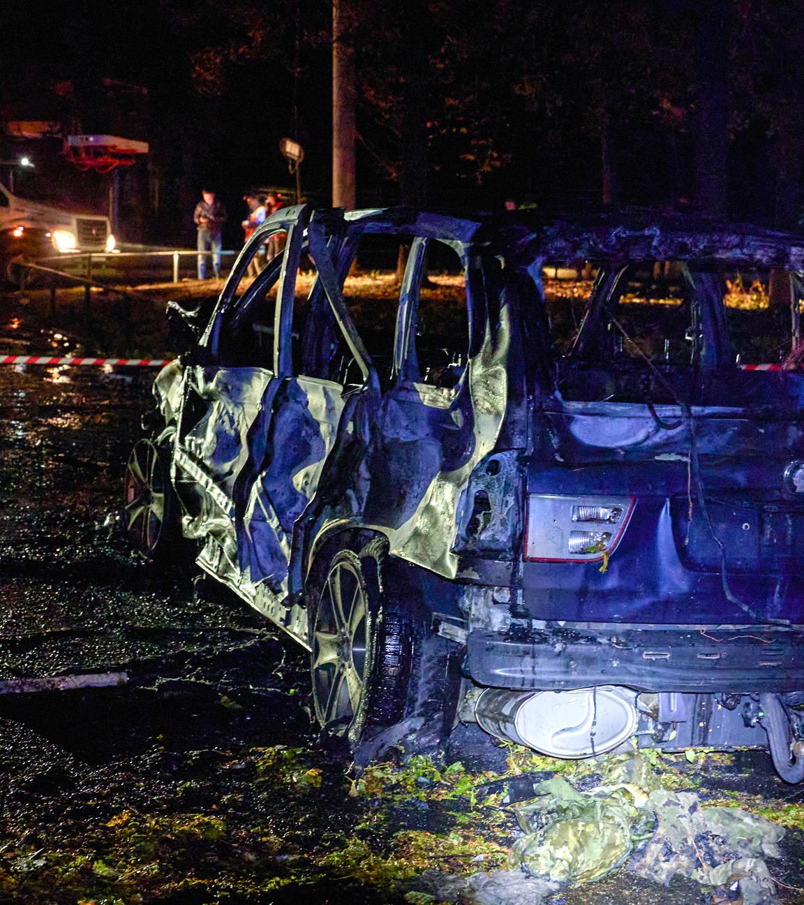 A burned car at the site of a shelling in Kharkiv, Ukraine, late 20 September 2024, amid the ongoing Russian invasion.