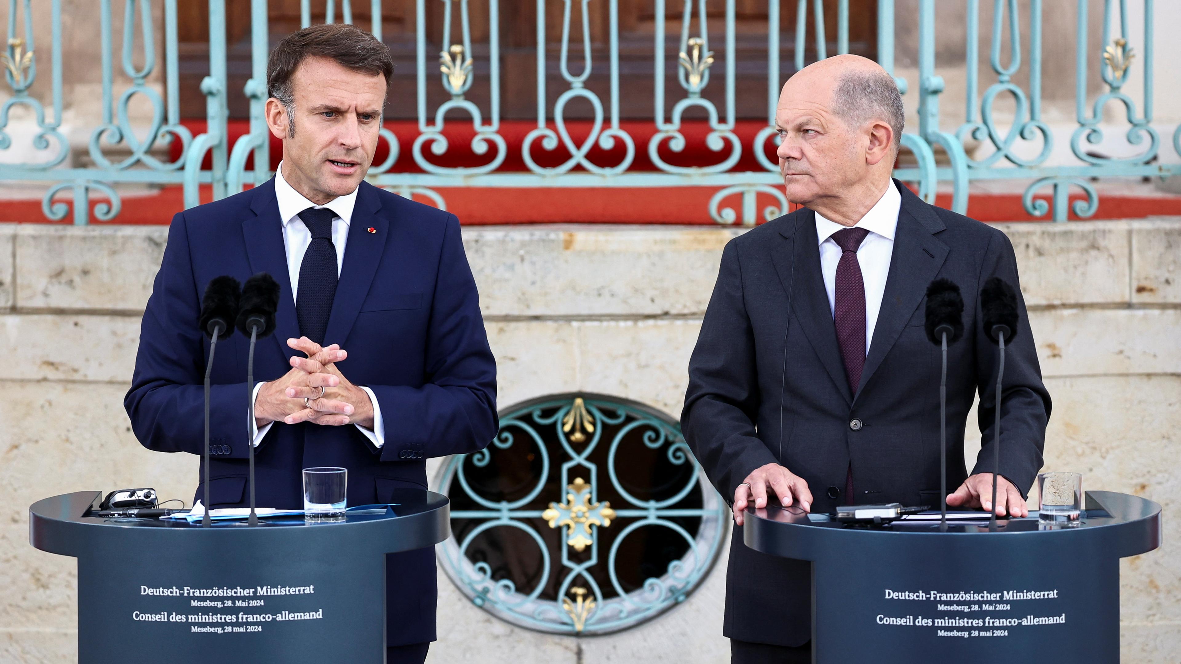 German Chancellor Olaf Scholz (R) and France's President Emmanuel Macron attend a press conference at the Schloss Meseberg palace in Meseberg, eastern Germany, on May 28, 2024.