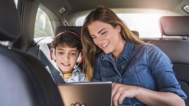 Junge und Mädchen mit Tablet im Auto
