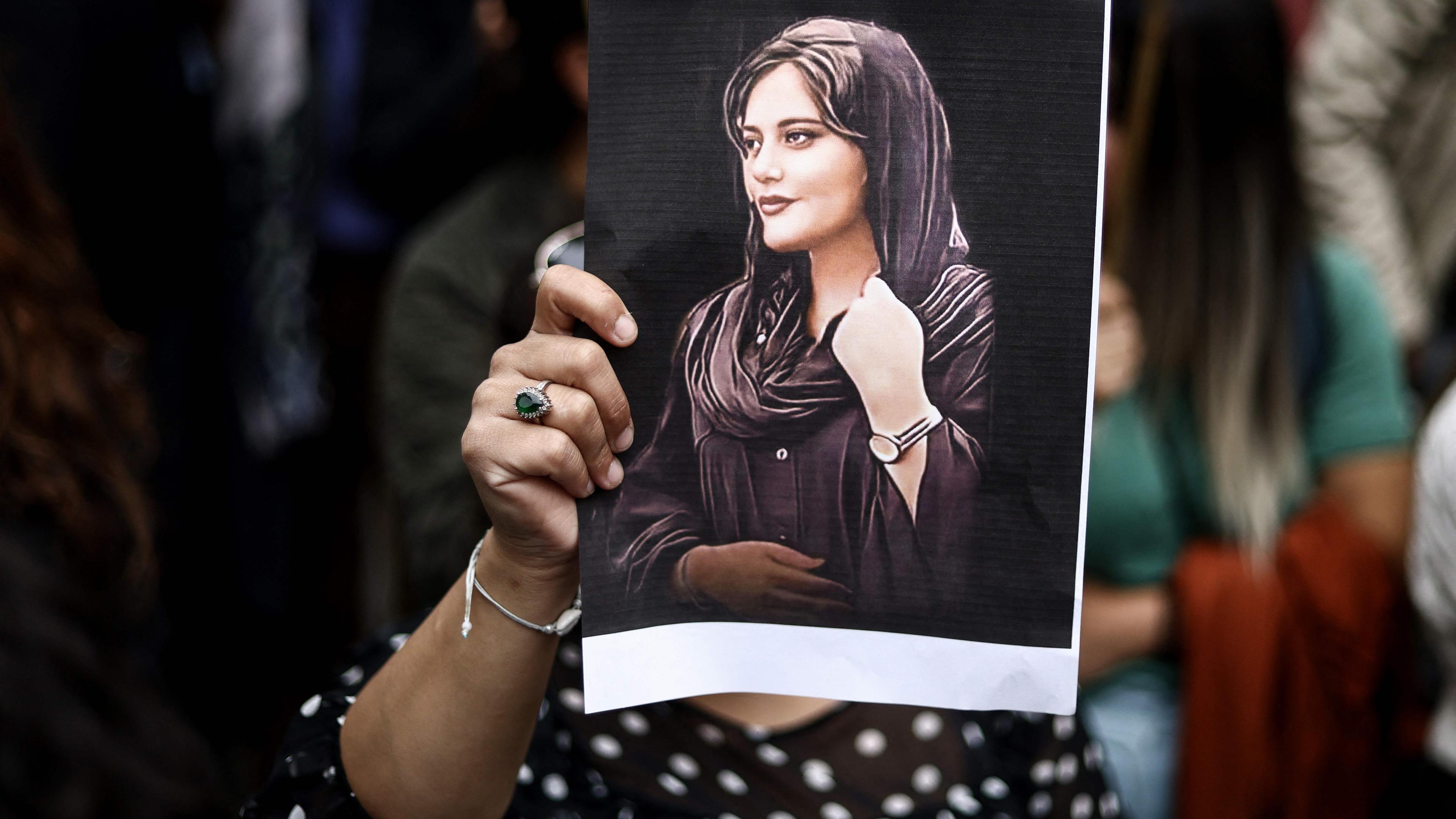 Ein Demonstrant hält ein Porträt von Mahsa Amini während einer Demonstration zu ihrer Unterstützung vor einer iranischen Botschaft