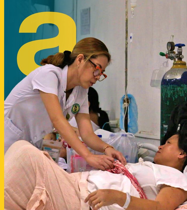 Eine Krankenpflegerin aus den Philippinen am Krankenhausbett