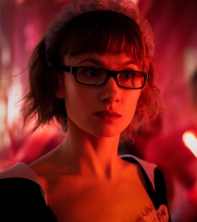 Nahaufnahme von Doro Decker (Alina Levshin), die als Haushaltshilfe mit Häubchen verkleidet ist.