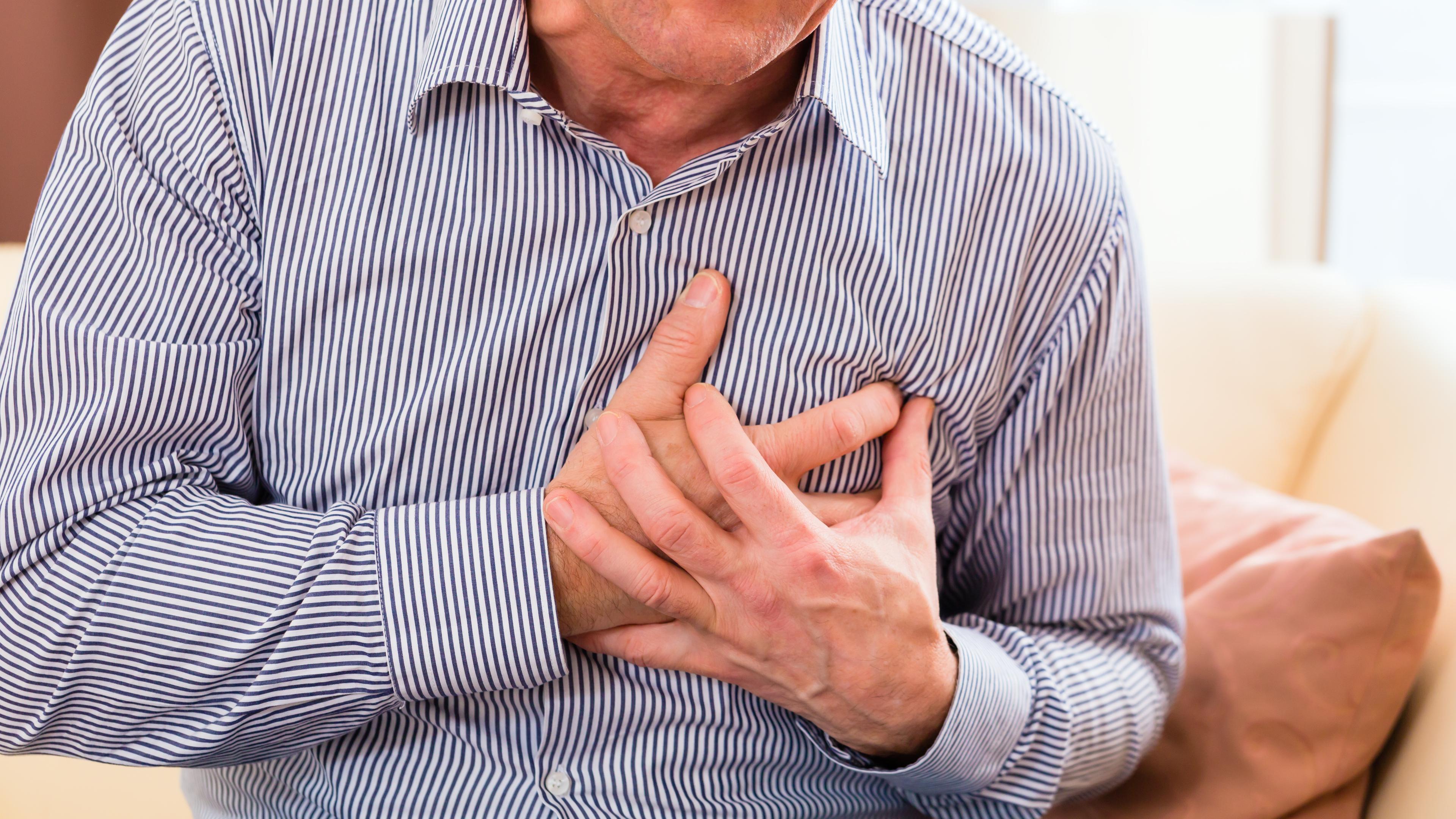 old man holding breast because of heart infarction