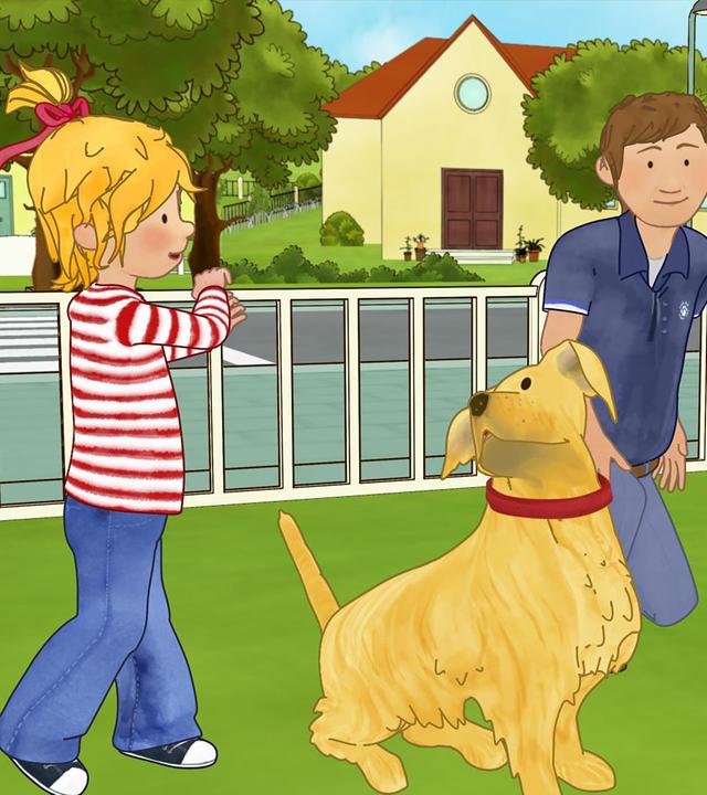 Conni ist im Park und lernt den Umgang mit Hunden.