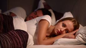 Woman lying awake in bed