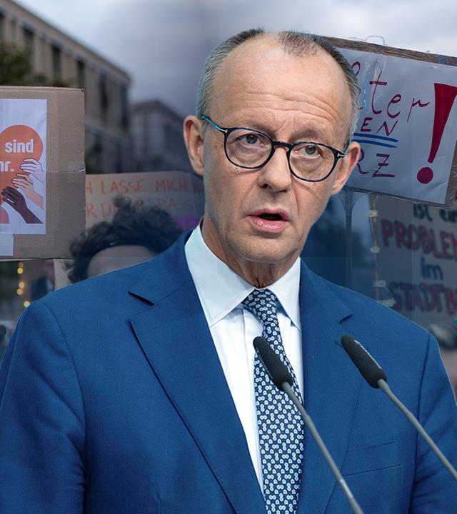 Bundeskanzler Friedrich Merz an einem grauen Podium mit CDU-Logo darauf.