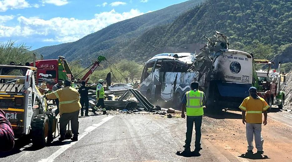 A tow truck moves a bus at the scene of a road accident after a bus carrying dozens of mostly Venezuelan migrants crashed and left some of the passengers dead and others injured, on the highway near Tepelmeme Villa de Morelos, in the southern state of Oaxaca, Mexico in this photo obtained by Reuters on October 6, 2023.