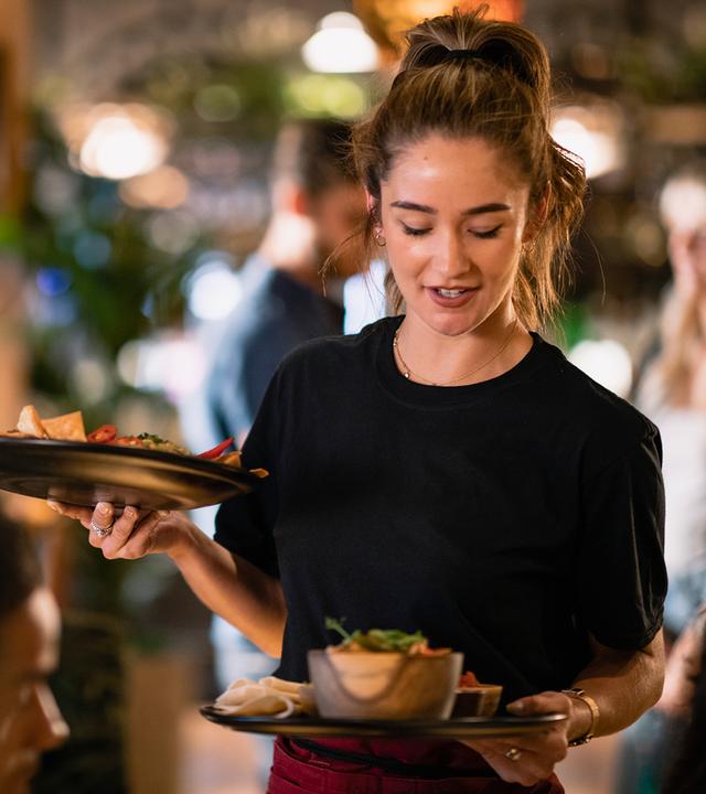 Junge Servicekraft in einem Restaurant