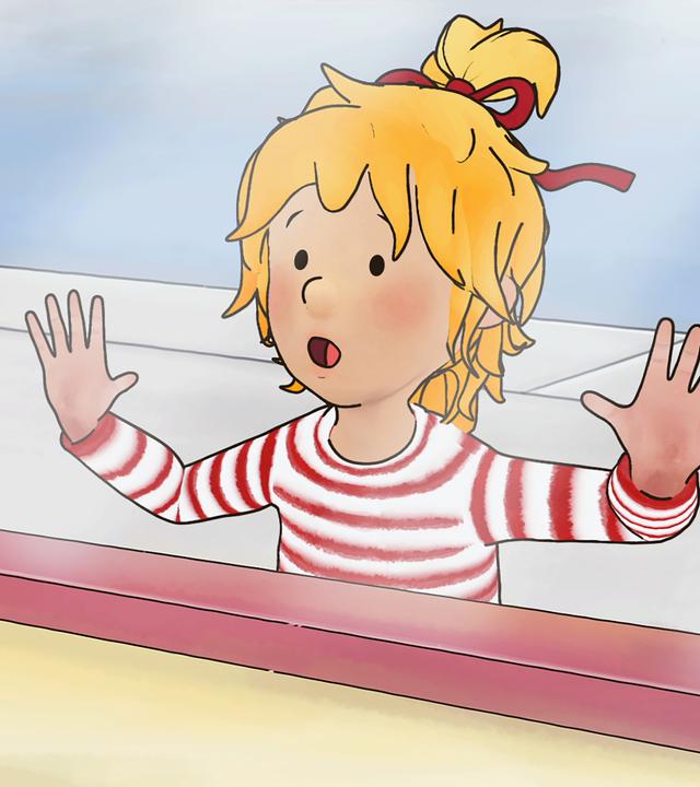 Conni sieht sich ein Fahrrad im Schaufenster an.