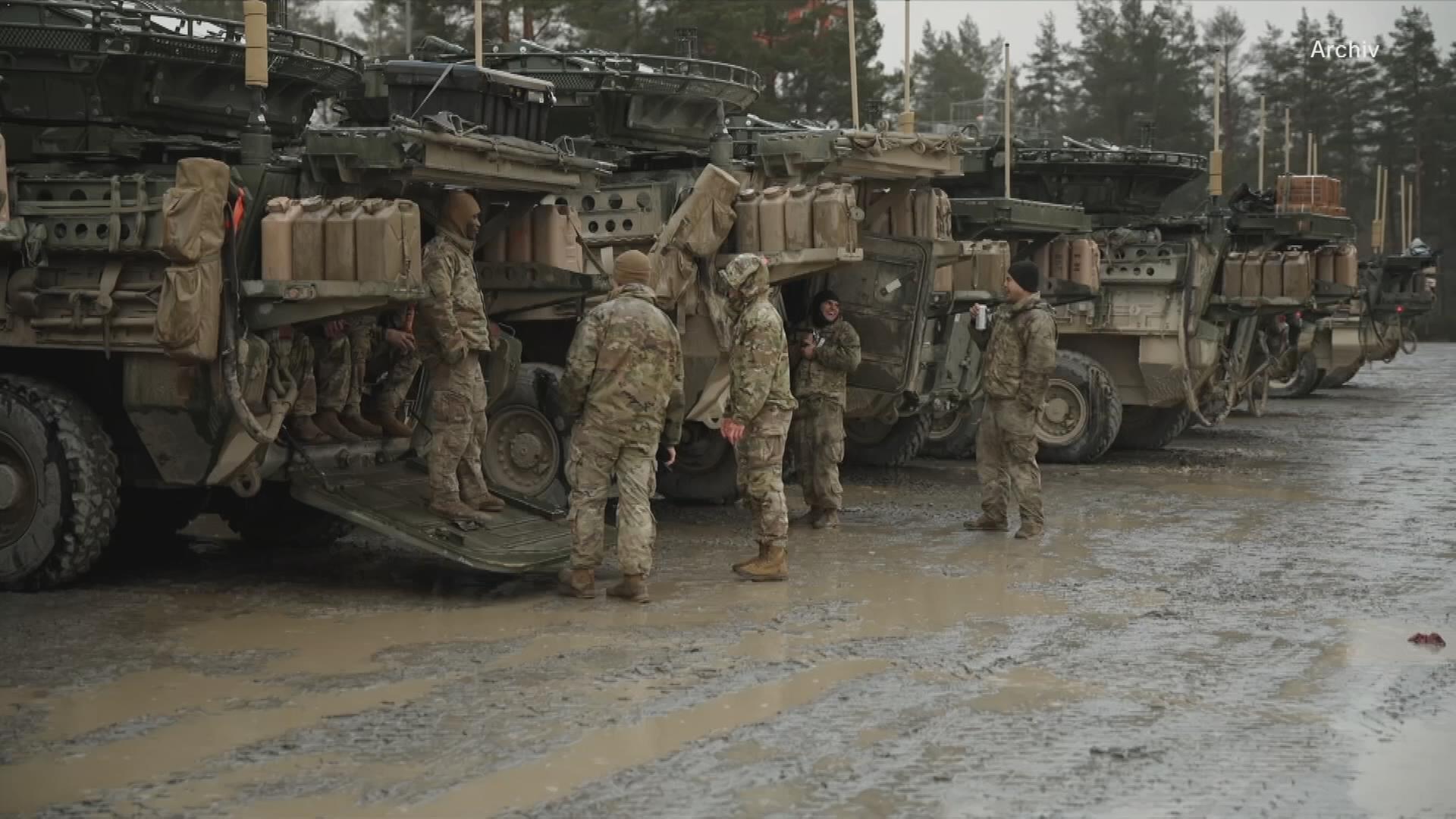 US-Soldaten vor Militärfahrzeugen
