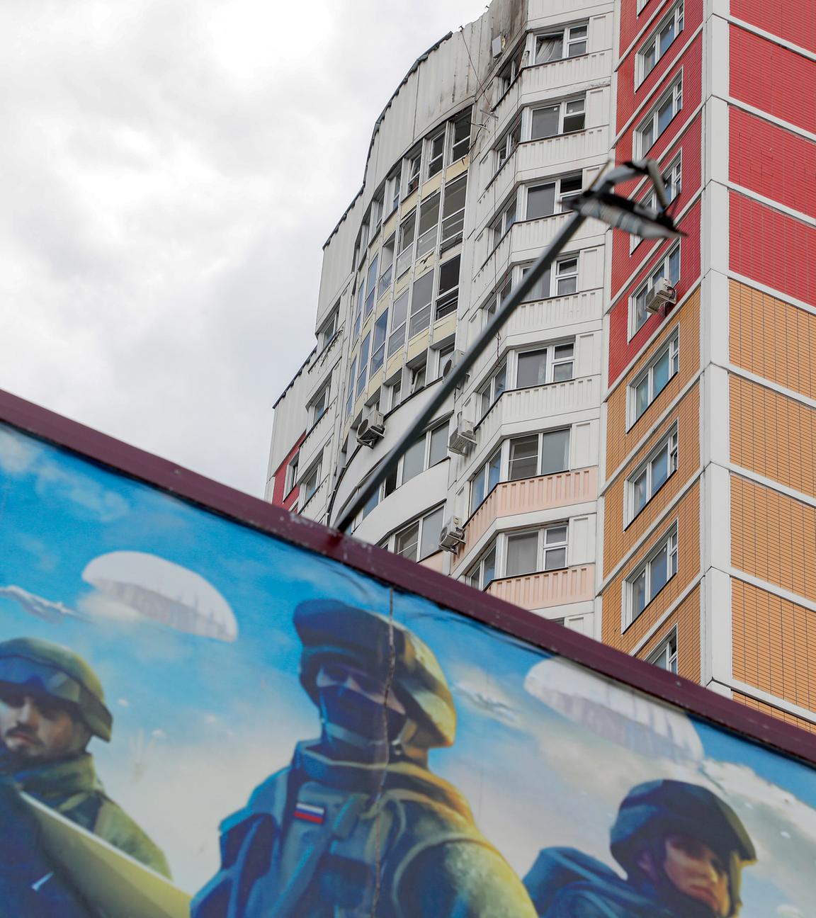 Vor einer Häuserfront in Moskau ist ein Bild russischer Soldaten zu sehen.