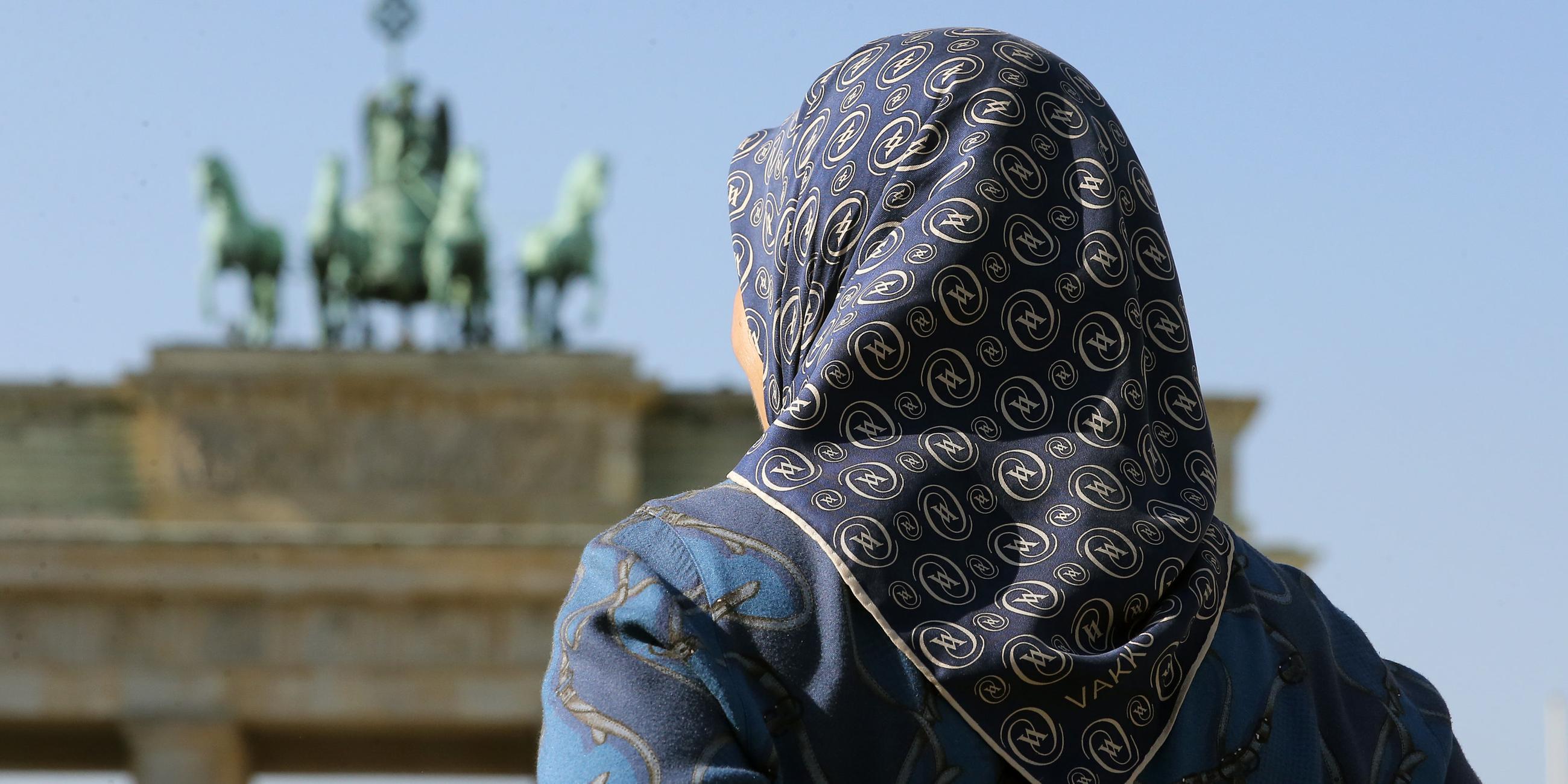 Archiv: eine muslimische frau mit kopftuch steht am 27.09.2016 vor dem brandenburger tor in berlin.