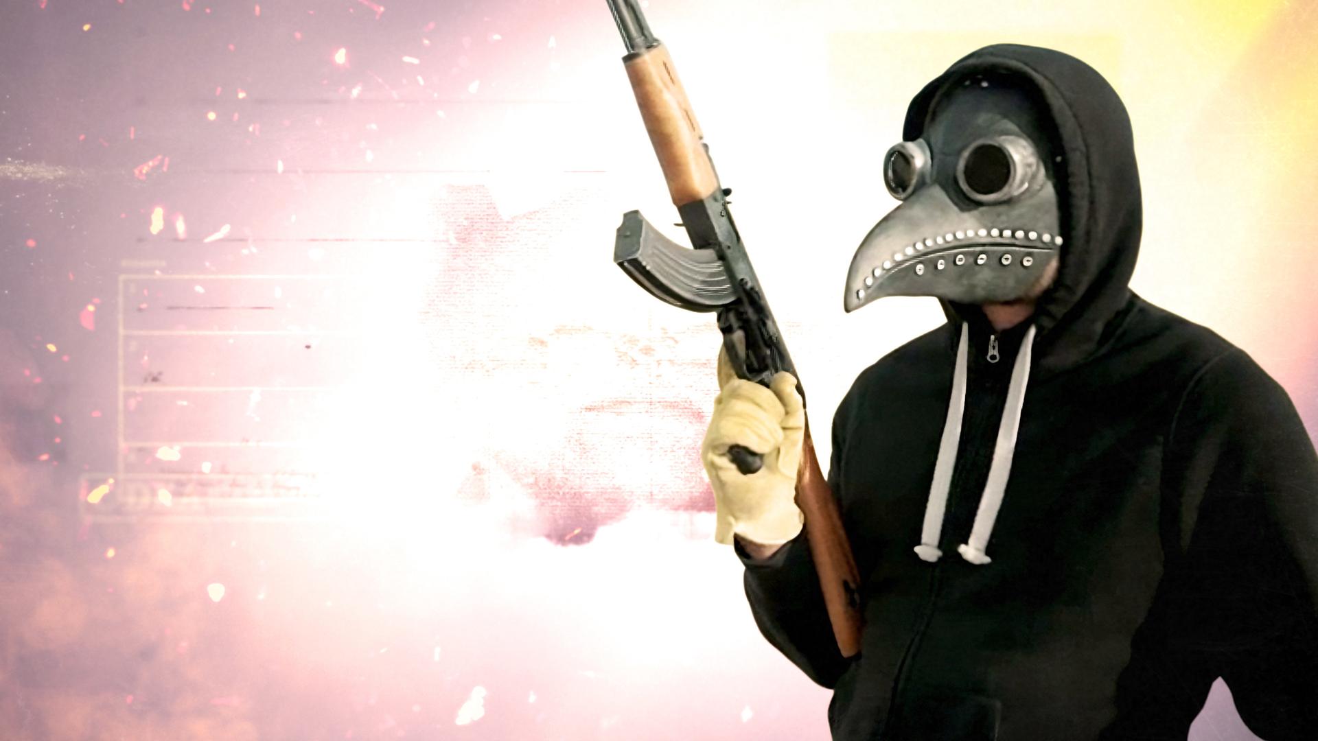 Montage: Ein Mann trägt eine Pestmaske und einen Kapuzenpulli. Er hält ein Gewehr und schaut zur Seite. Im Hintergrund brennt ein Feuer in der Nacht, Funken sprühen.