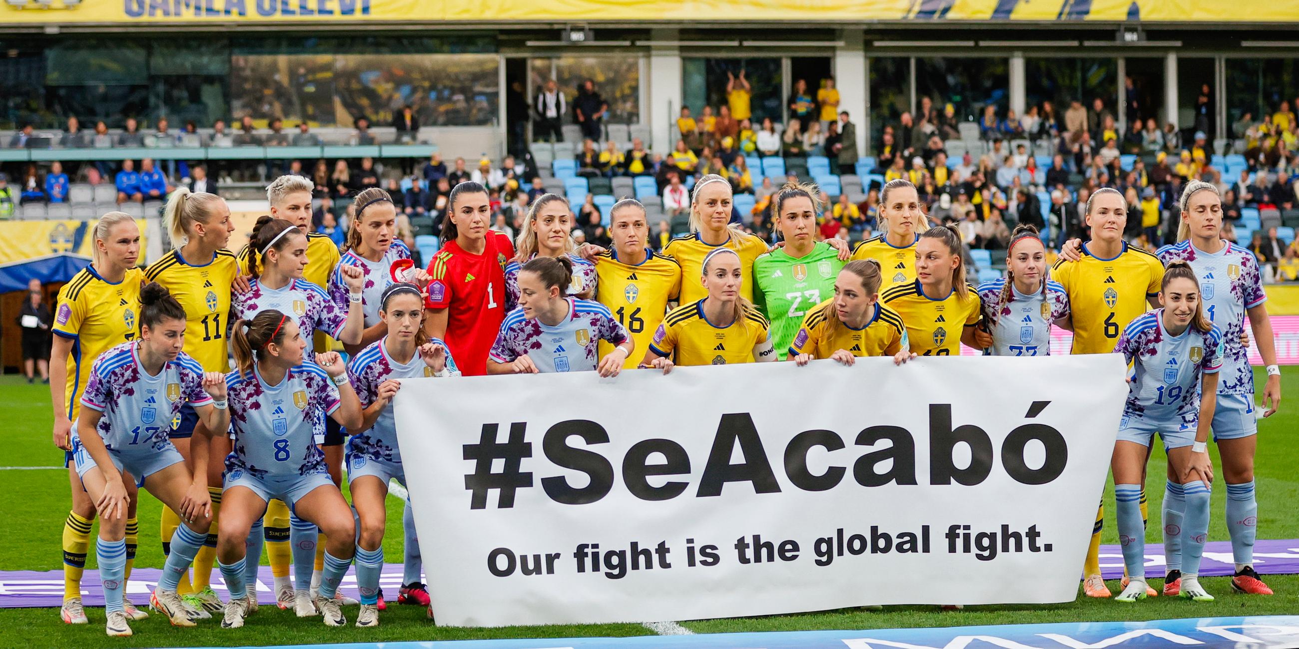 Nationalspielerinnen von Schweden und Spanien zeigen ein Transparent mit der Aufschrift: "Schluss jetzt"
