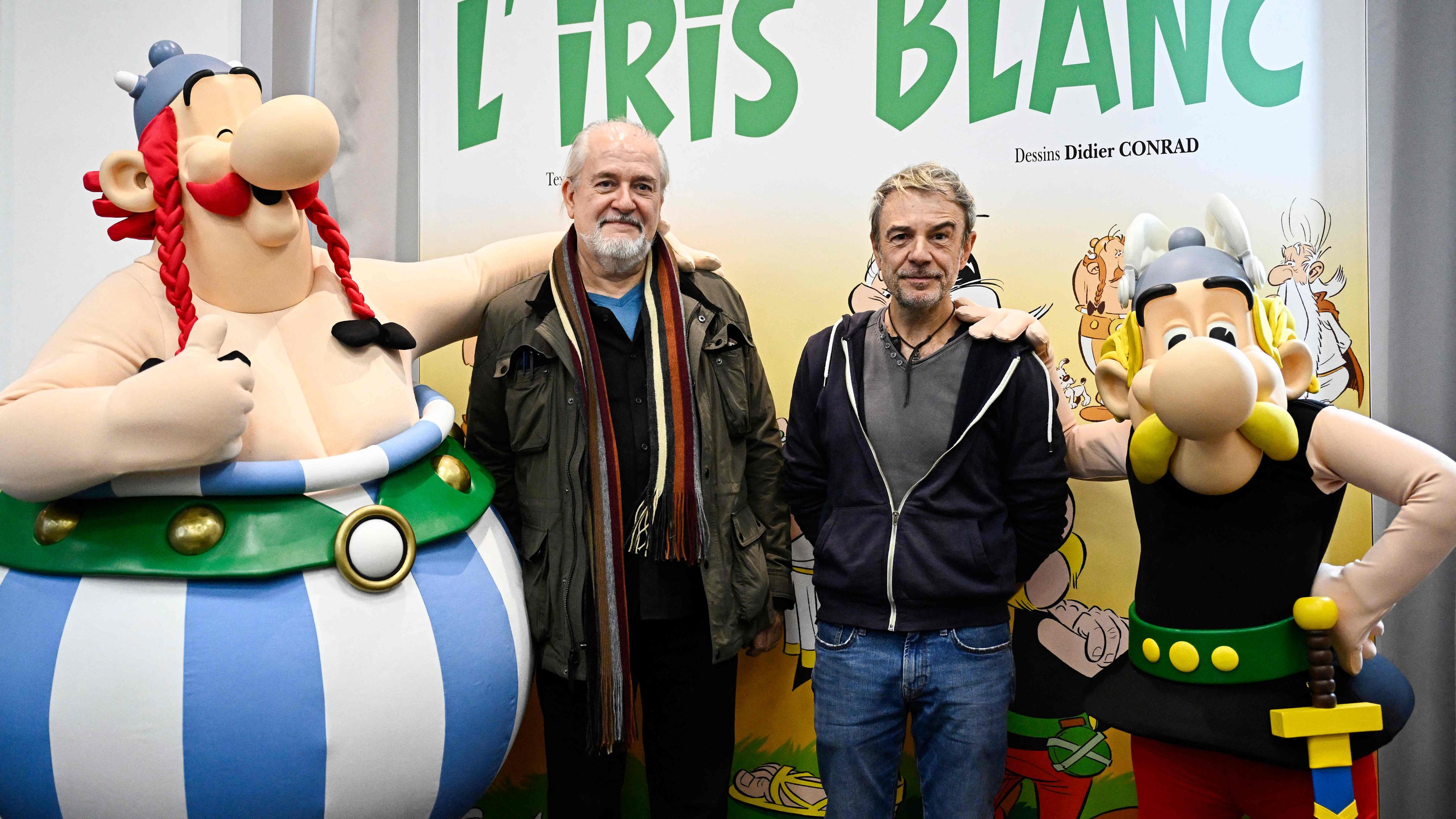 Der französische Cartoonist Didier Conrad (C-L) posiert mit dem französischen Schriftsteller Fabrice Caro (alias Fabcaro) (C-R) nach der Präsentation des neuen Comix-Albums „Asterix“ im Hachette Livre-Verlag in Vanves bei Paris am 16. 10. 2023