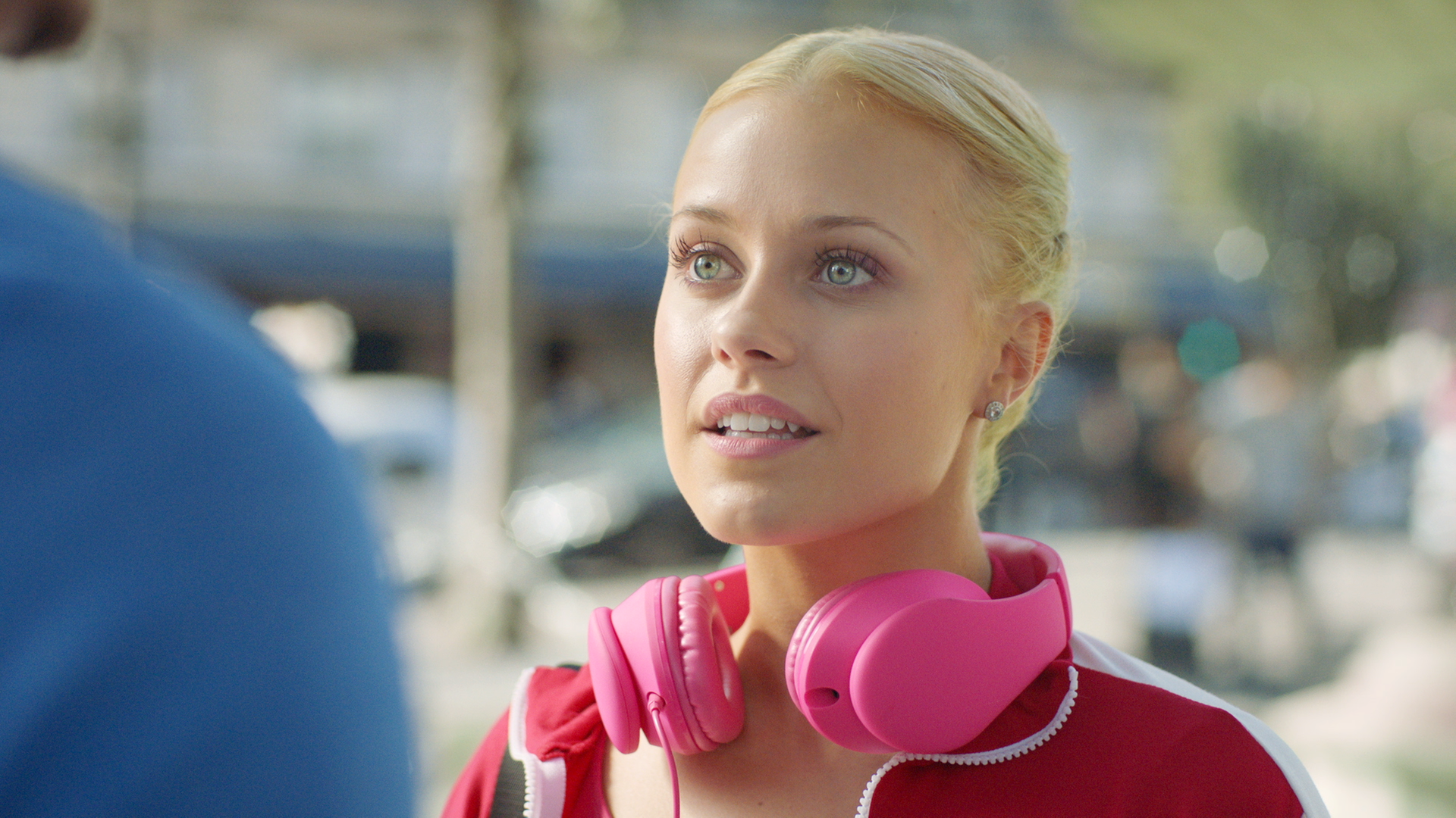 Lena trifft Armando Castillo auf der Straße. Um ihren Hals trägt sie ihre pinken Kopfhörer.