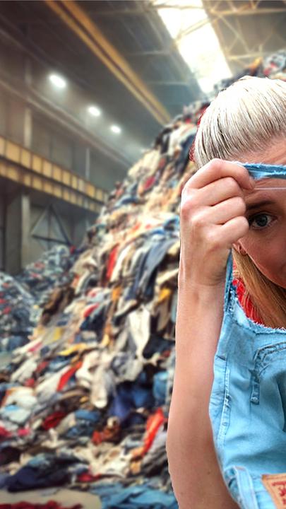 Pia Osterhaus sitzt vor einem Haufen alter Jeans und schaut durch das Loch einer kaputten Jeans.