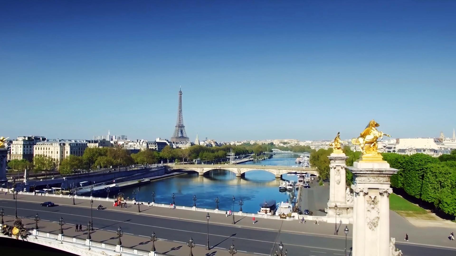 Paris mit Brücken über die Seine und Eiffelturm im Hintergrund.