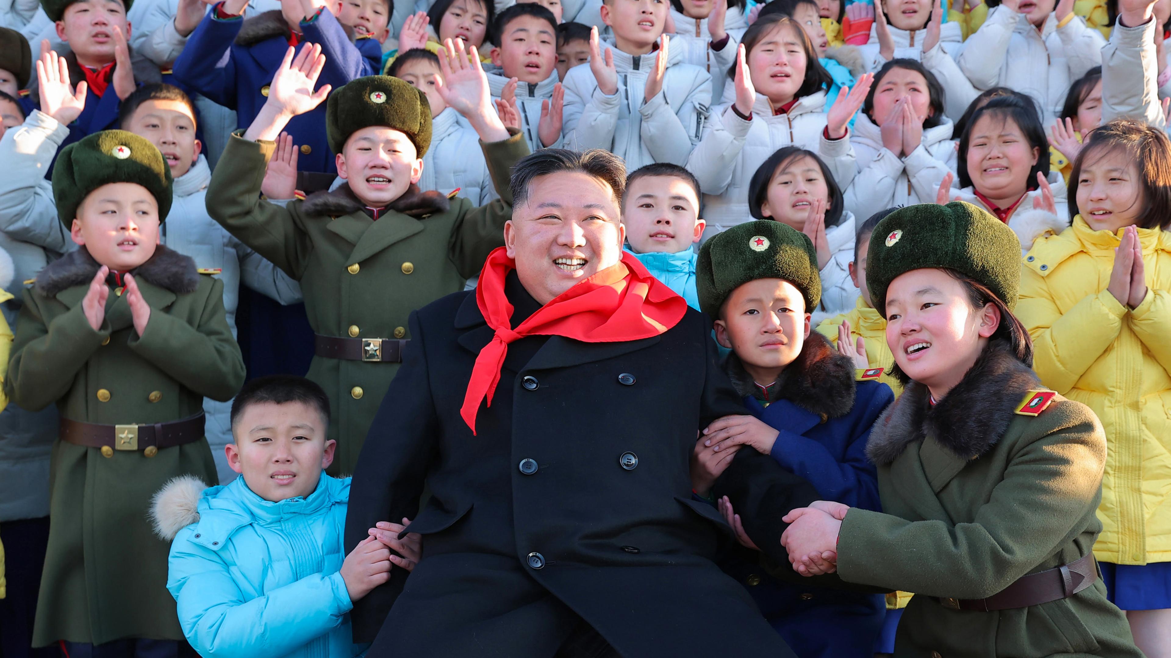 Ruler Kim Jong-un stands close to the public at a crowded event.