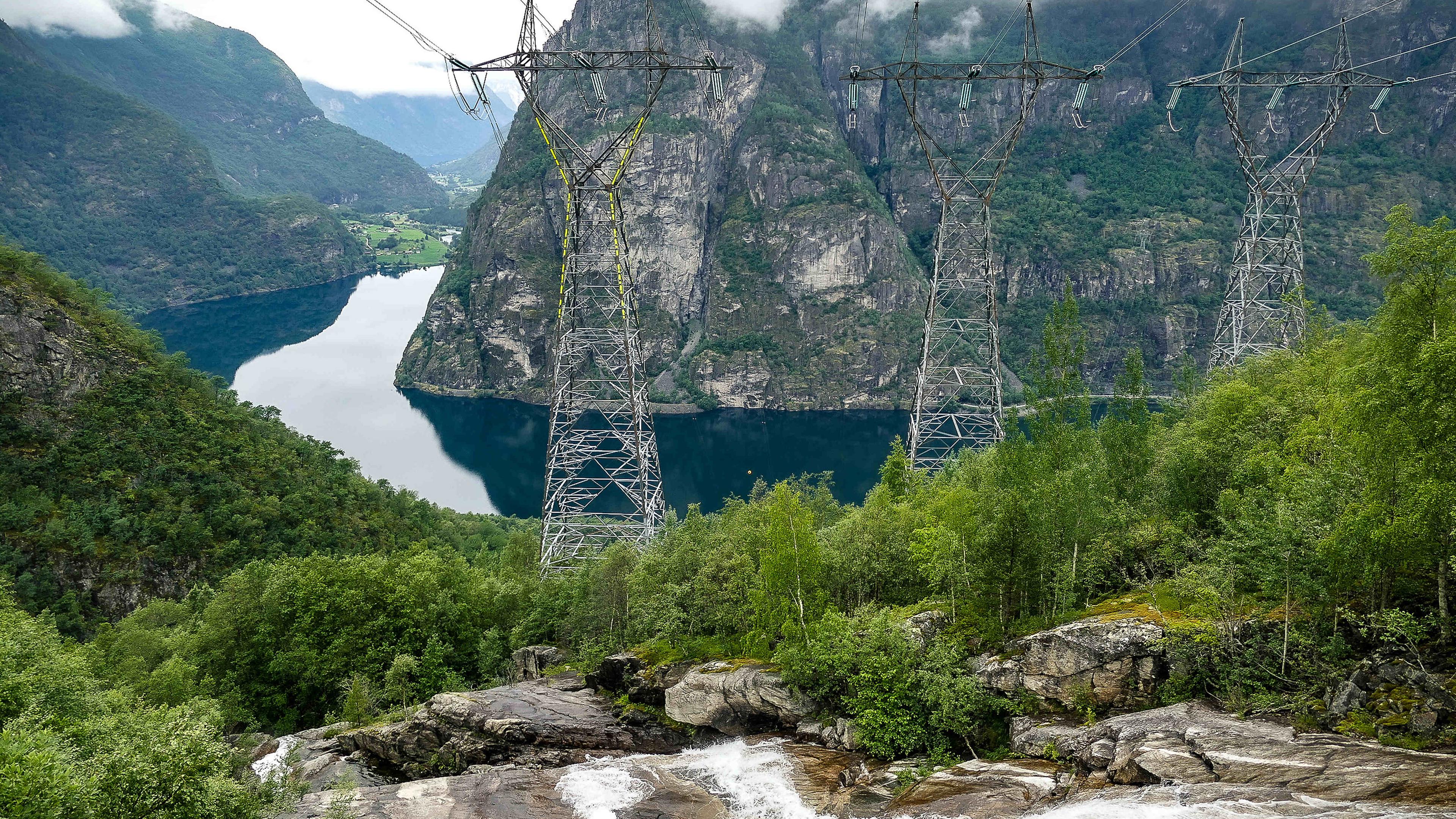 Norwegischer Fjord mit Strommasten