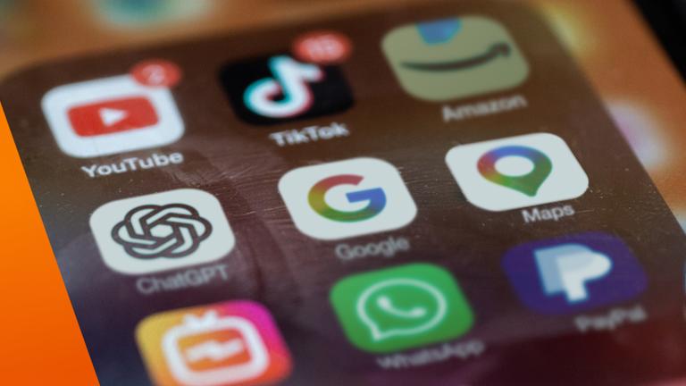 Nahaufnahme eines Smartphone-Bildschirms mit verschiedenen App-Symbolen, darunter Google, YouTube, WhatsApp, Maps, PayPal, Amazon, TikTok und ChatGPT. Die Icons sind in einem Raster angeordnet, einige mit Benachrichtigungsanzeigen. Das Bild steht sinnbildlich für die starke Präsenz großer Digitalkonzerne im Alltag.