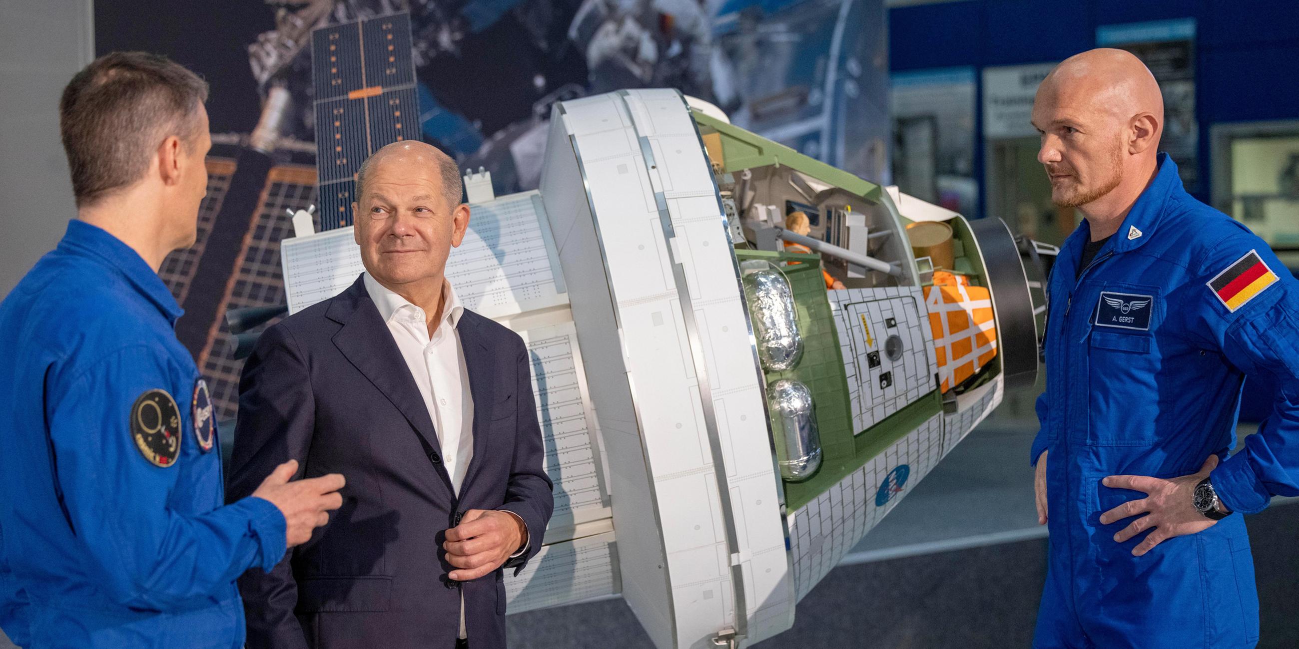 Olaf Scholz informiert sich bei den beiden Astronauten Matthias Maurer und Alexander Gerst über das Raumschiff Modul Orion am 01.09.2023.