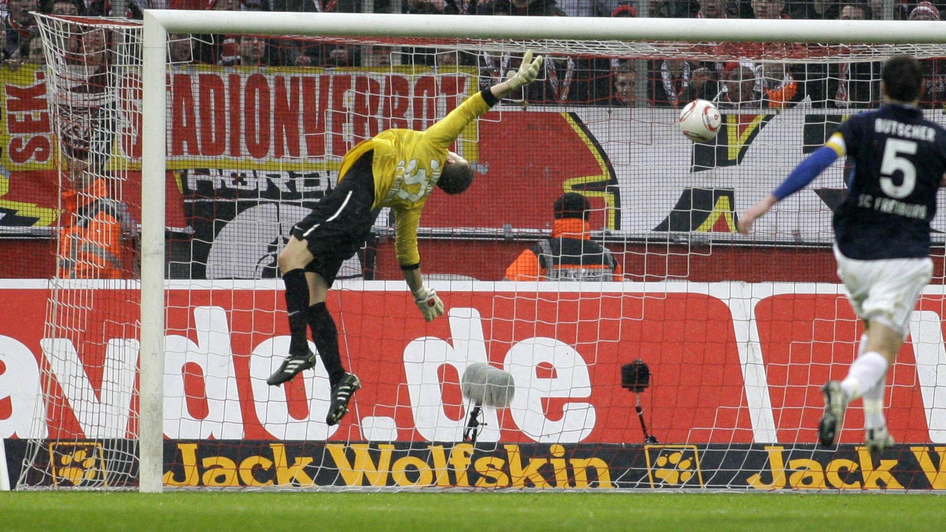 Freiburg s goalkeeper Oliver Baumann gets a goal scored by Lukas Podolski of Köln during the German first division Bundesliga match between 1.FC Köln and SC Freiburg, RheinEnergieStadion in Köln on February 26., 2011.