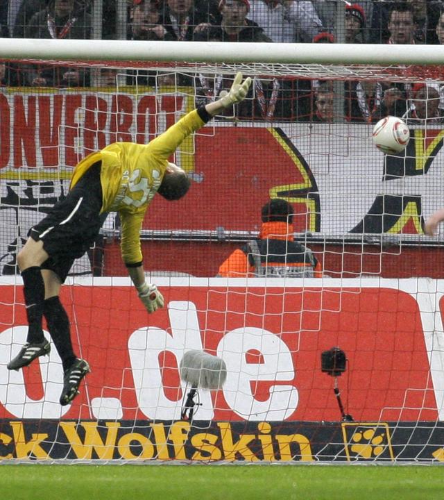 Freiburg s goalkeeper Oliver Baumann gets a goal scored by Lukas Podolski of Köln during the German first division Bundesliga match between 1.FC Köln and SC Freiburg, RheinEnergieStadion in Köln on February 26., 2011.