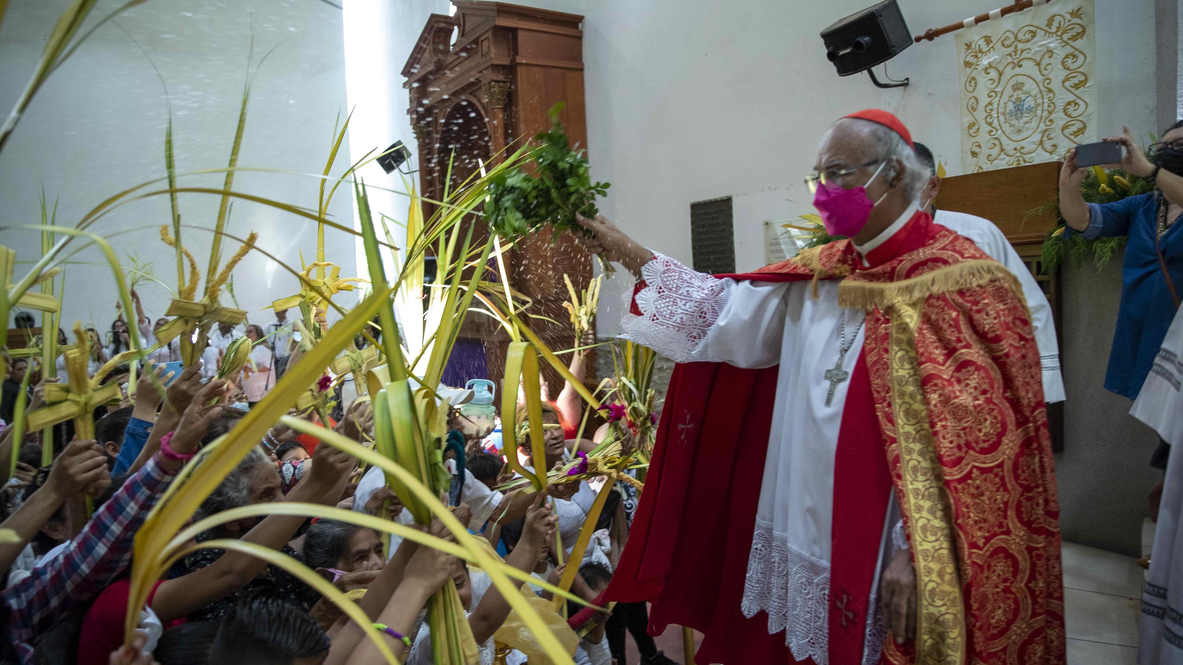Gottesdienst in Nicaragua. Ein Priester hält einen Gottesdienst zum Palmsonntag vor einer Menge Menschen.