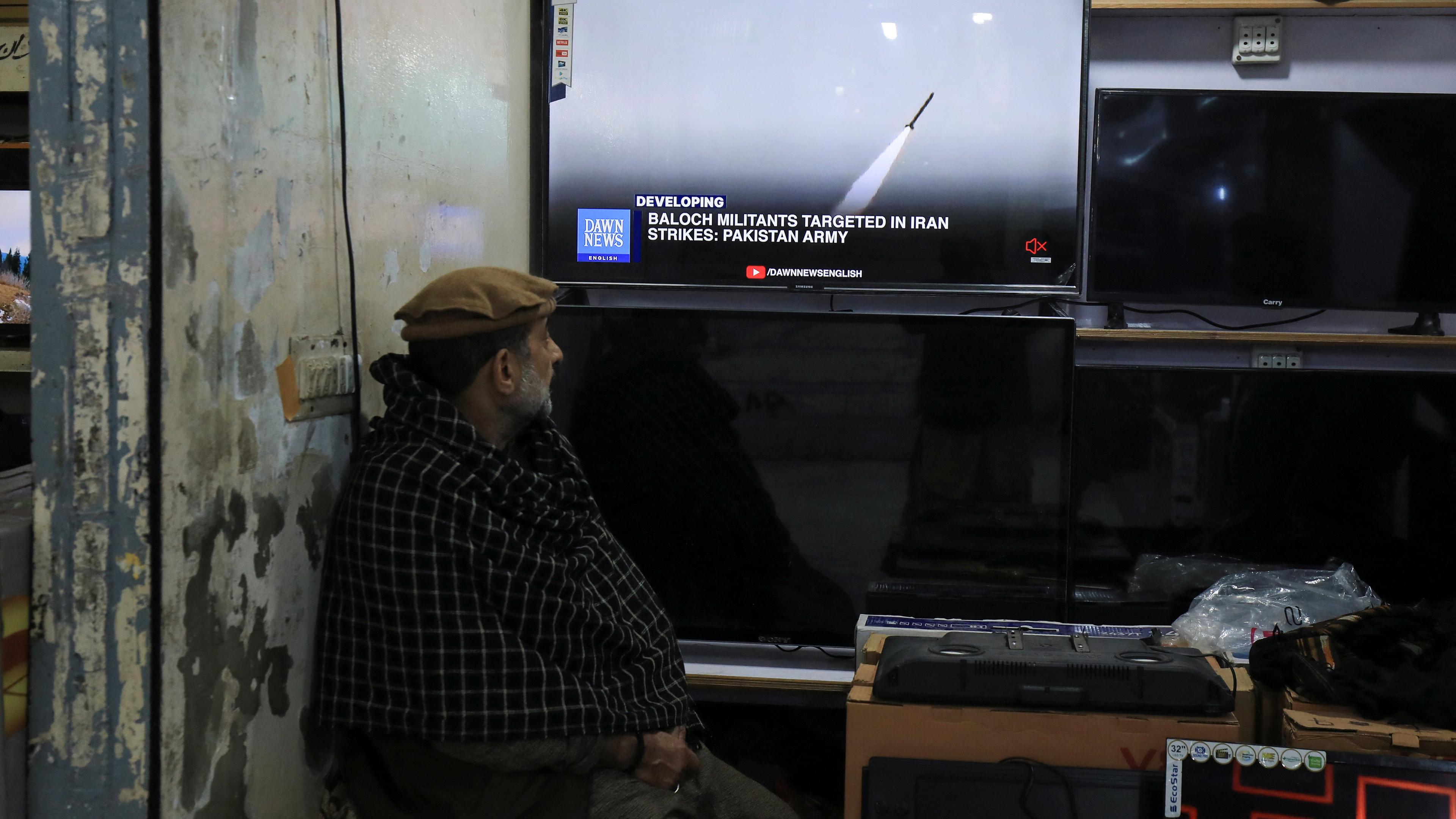 Ein Mann sieht einen Nachrichtensender im Fernsehen in einem Geschäft, nachdem das pakistanische Außenministerium sagte, das Land habe Angriffe im Iran gegen militante Separatisten durchgeführt