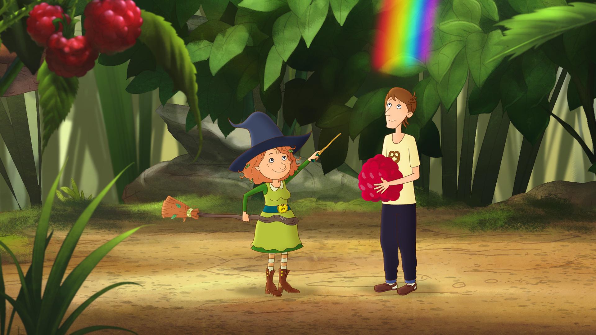 Papa Paul steht mit einer Himbeere in seinen Arme im magischen Garten. Neben ihm schwingt Petronella Apfelmus einen Zauberstab. Über ihm sind Regenbogenfarben.