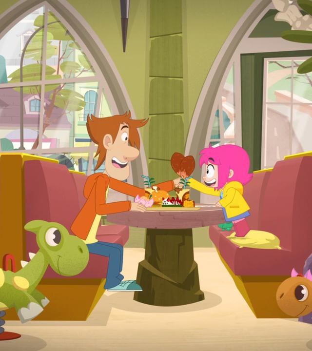 Rebecca und ihr Papa sitzen im Dino-Café und stoßen mit zwei Hähnchenkeulen an.